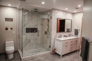 bathroom with glass shower and white vanity
