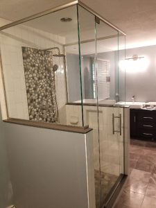 frameless glass shower door with an inline panel and 90 degree return