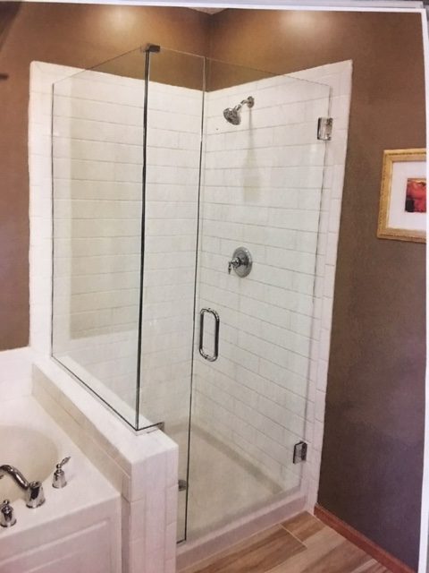 FRAMELESS HEAVY GLASS 90 DEGREE CORNER SHOWER ENCLOSURE WITH A DUAL SWING DOOR, A NOTCHED STATIONARY PANEL, AND A STATIONARY BUTTRESS RETURN PANEL
